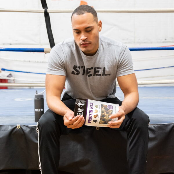 power-up-protein-mix-trail-mix-pdp-image-man-in-boxing-gym Man Eating Power Up Protein Mix Trail Mix